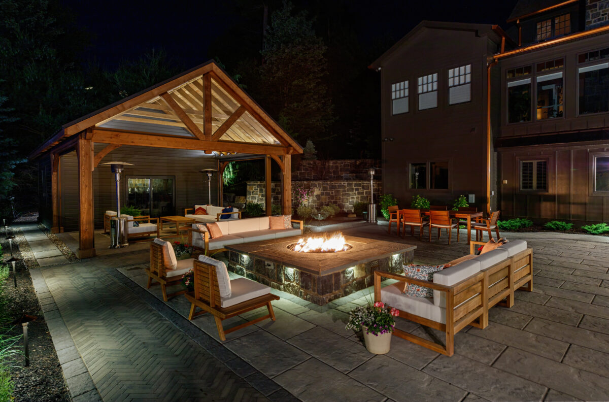 Cushioned bench seating surrounding a cozy fire pit